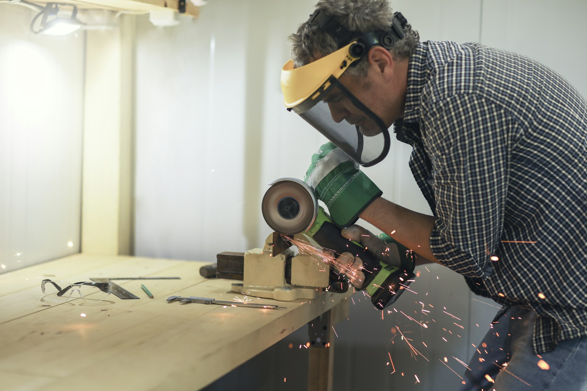 a man is engaged in locksmithing, works with metal